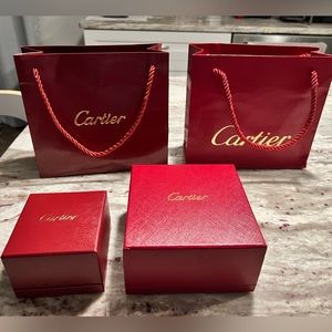 Two Cartier EMPTY boxes with gist bags from earrings and a bracelet